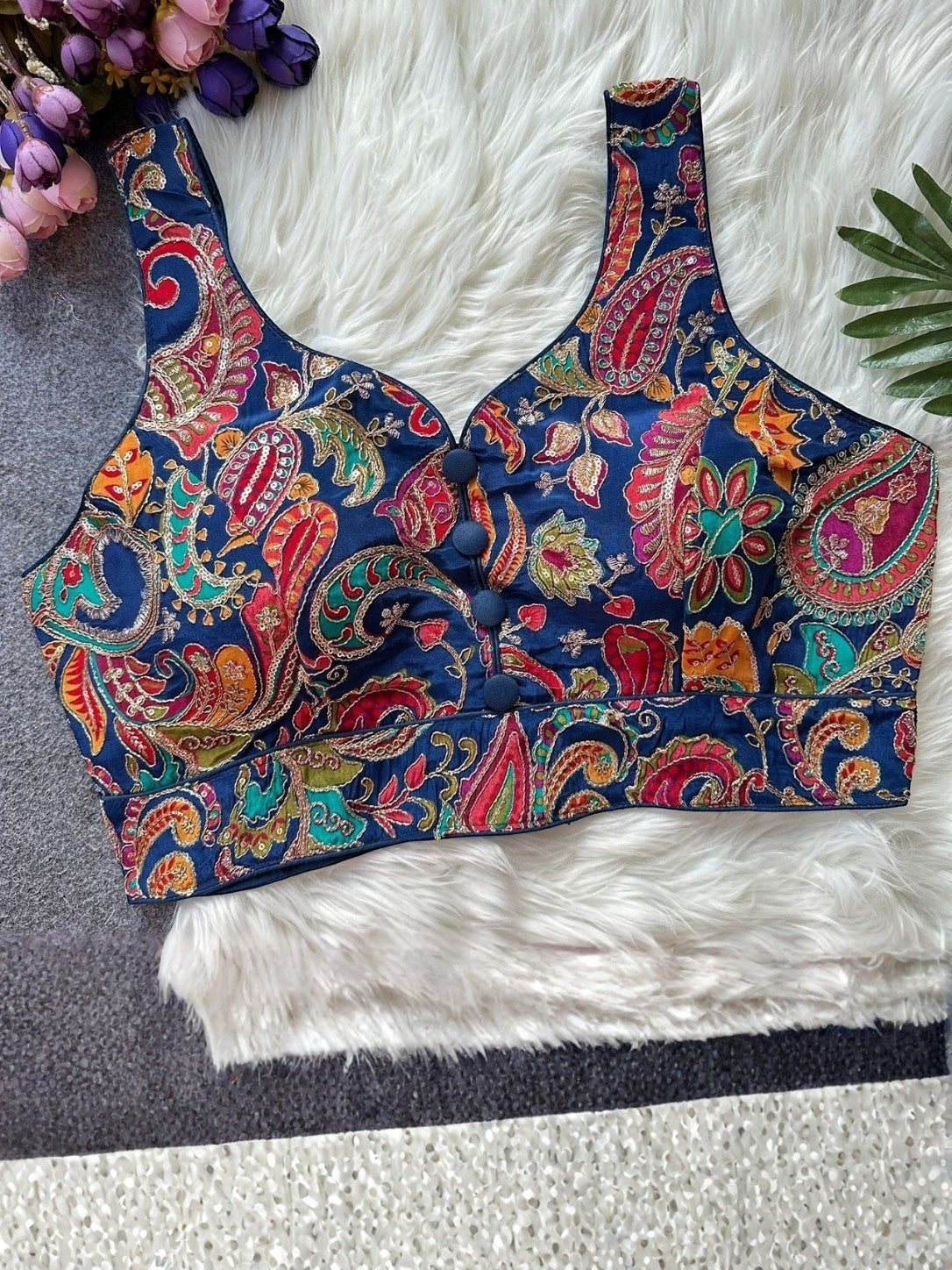 AMA B navy blue sleeveless crepe blouse with colorful paisley embroidery and button front detail.