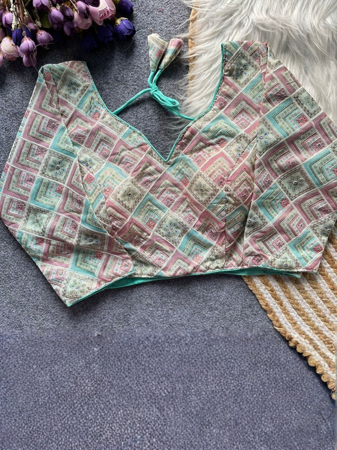 AMAB designer printed blouse with V-neck, tie closure, and pastel geometric pattern in pink, blue, and cream. Silk blend.