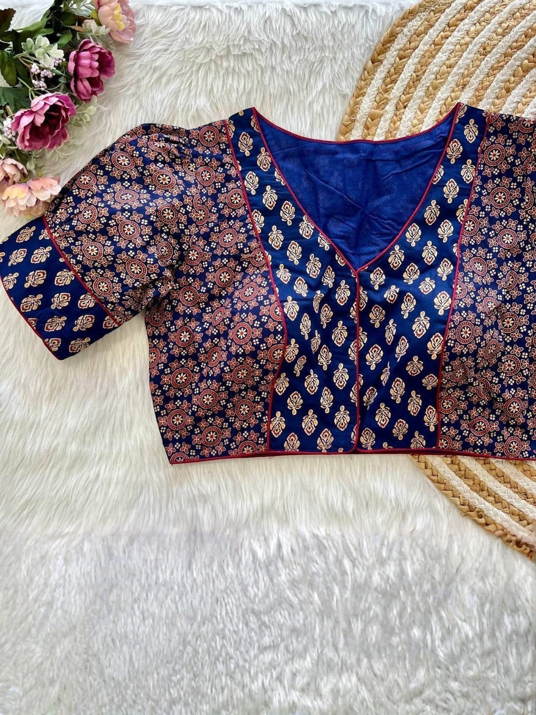 AMAB navy blue cotton blouse with puff sleeves, front open design, and intricate Ajrakh print. Features red trim.
