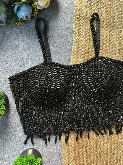 AMAB black sleeveless spaghetti blouse with heavy pearl and beadwork, fringe hem, and padded cups. Ideal for parties.