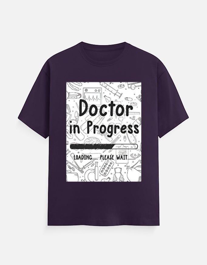 AMAB Doctor in Progress Loading Please Wait graphic t-shirt in deep purple cotton with medical icons.