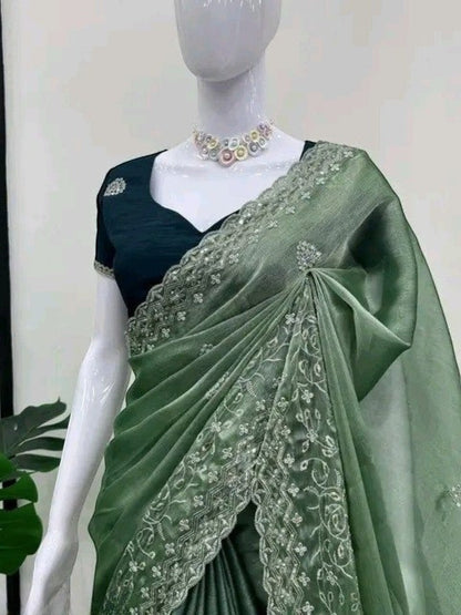 AMAB green silk blend saree with intricate embroidery and sequin work, paired with a dark green blouse. Perfect for festive occasions.