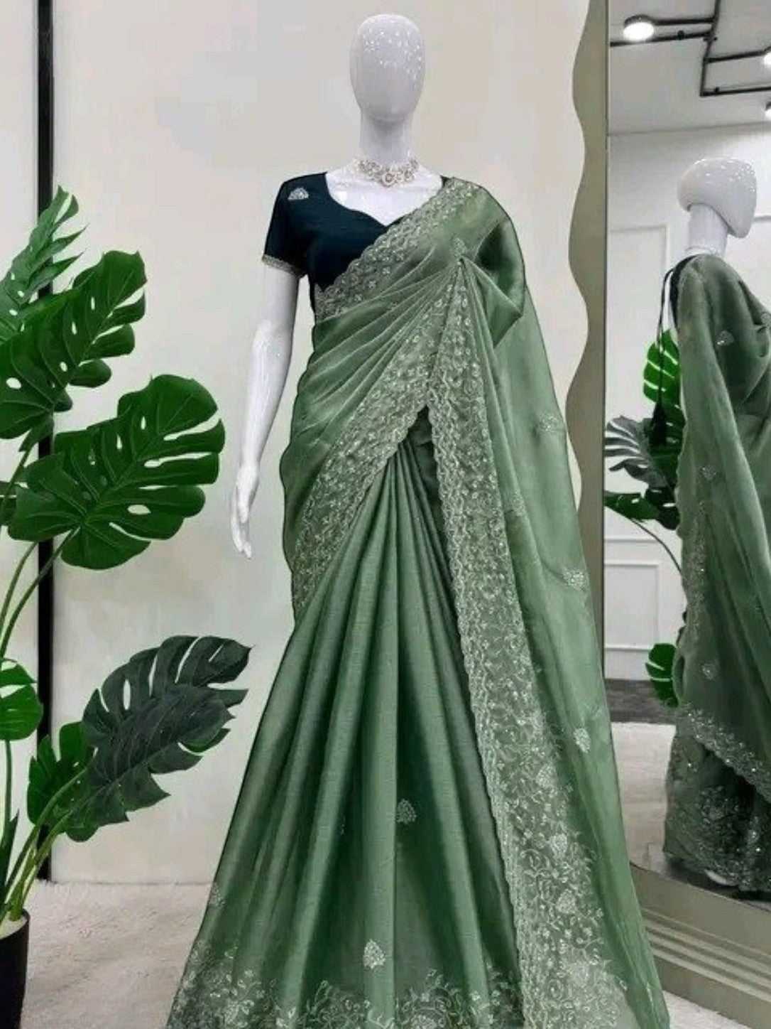 AMAB Embroidered silk blend saree in deep green with sequin work and matching blouse piece. Ideal for festive occasions.