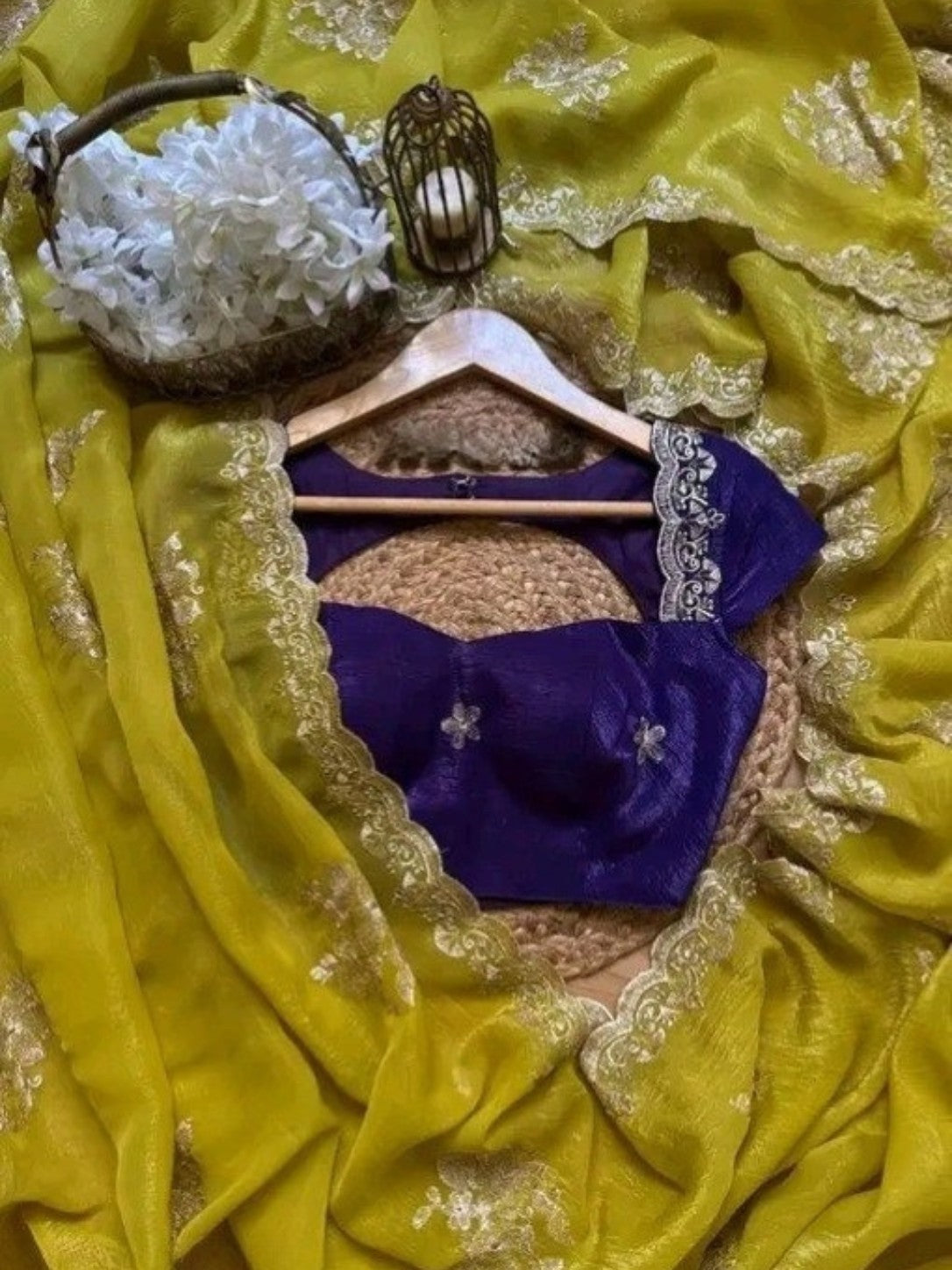 AMAB yellow silk blend saree with intricate floral embroidery and lace border, paired with a purple embroidered blouse.