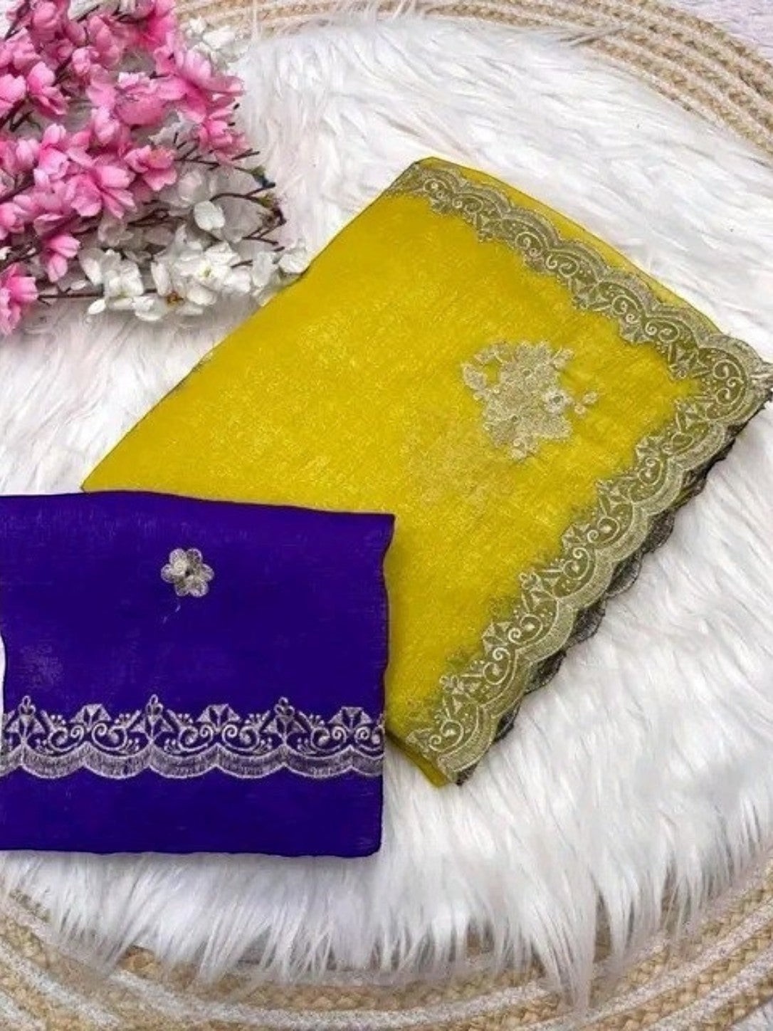 AMAB yellow silk blend saree with intricate embroidery and lace border, paired with a purple blouse.