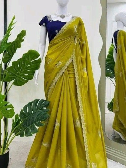 AMAB embroidered silk blend saree in vibrant yellow with a contrasting purple blouse, featuring floral embroidery and lace border.