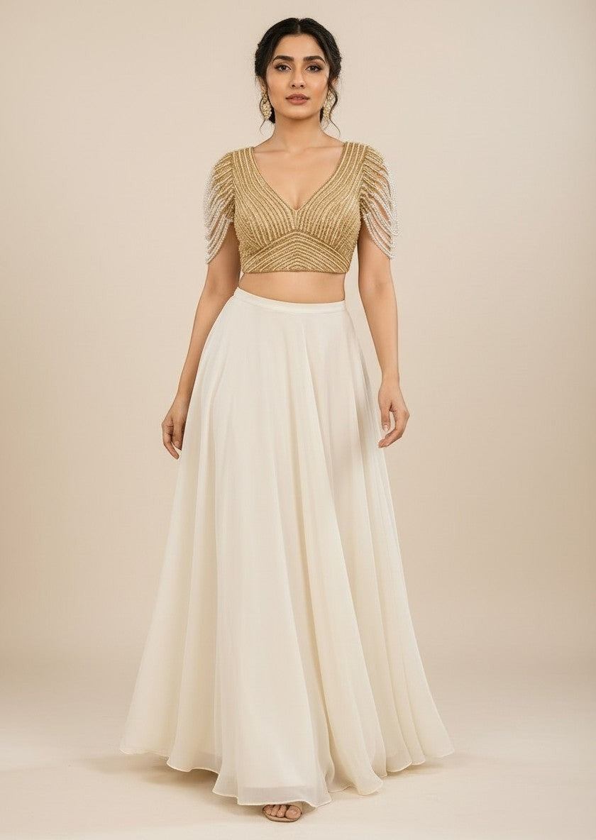 AMAB gold pure silk blouse with pearl bead fringe sleeves and V-neck, paired with a cream skirt.