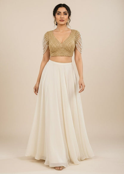 AMAB gold pure silk blouse with pearl bead fringe sleeves and V-neck, paired with a cream skirt.
