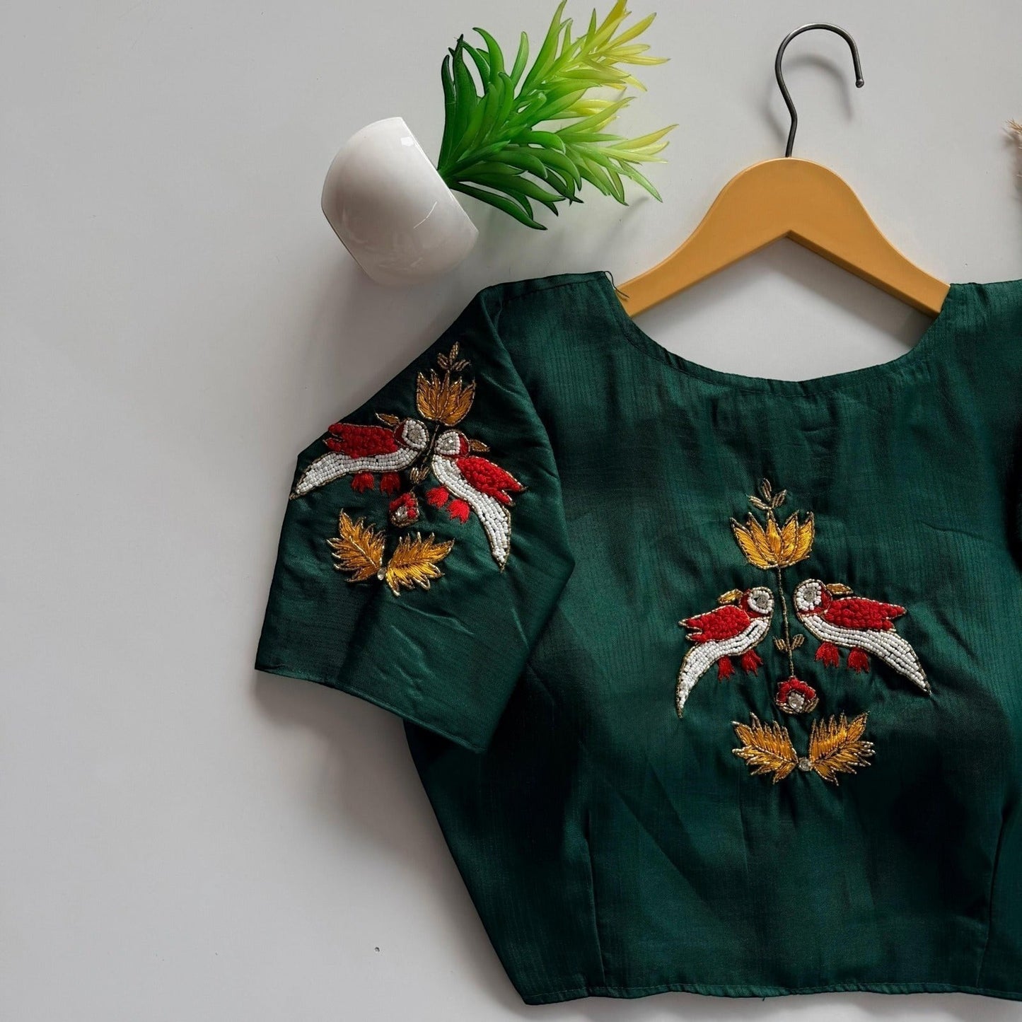 AMAB dark green haka silk blouse with intricate bird and floral embroidery on back and sleeves. Padded designer partywear.