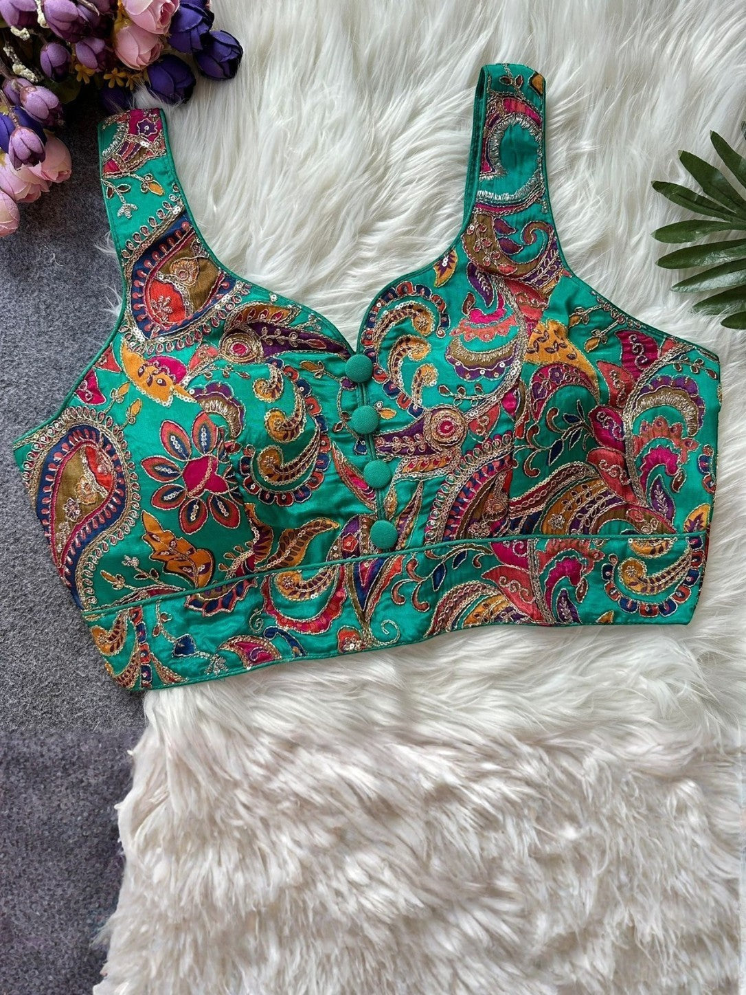 AMAB green paisley print sleeveless padded blouse with sequin embellishments and button detail.