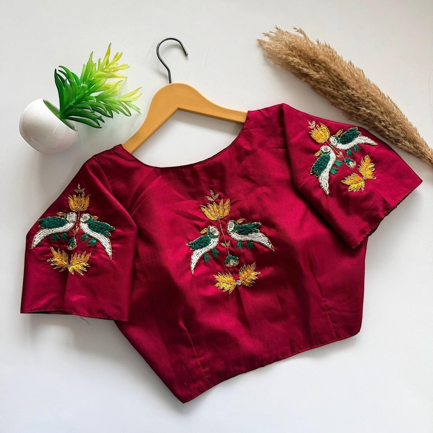 AMAB maroon haka silk blouse with embroidered birds and floral motifs on back and sleeves. Padded designer partywear.
