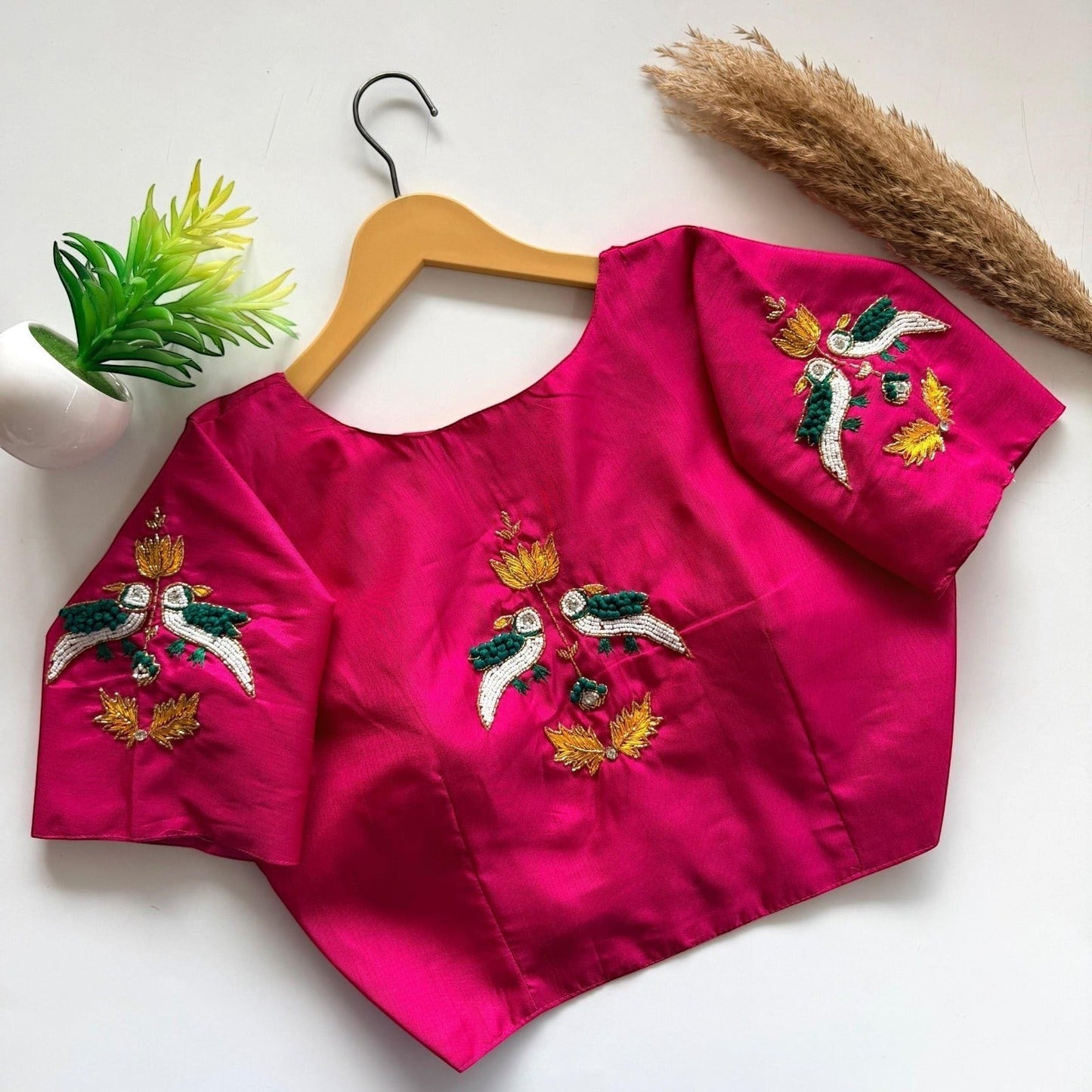 AMAB hot pink haka silk blouse with handcrafted bird embroidery on sleeves and back. Padded designer partywear.