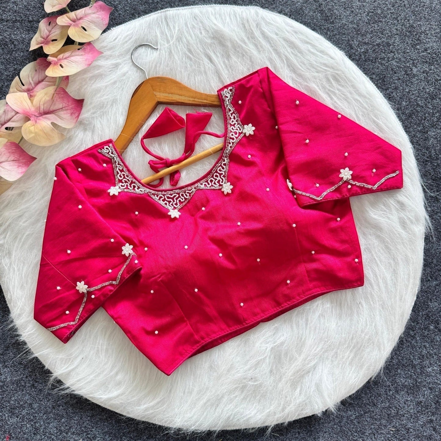AMAB hot pink silk blouse with all-over handwork, pearl embellishments, and padded design. Features intricate neckline and sleeve detailing.