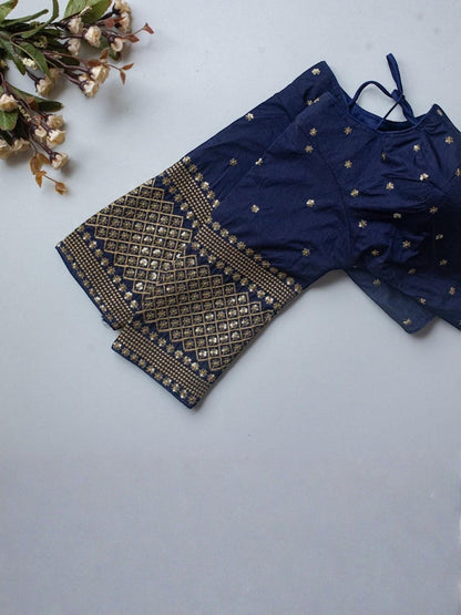AMAB navy blue Vichitra silk blouse with V-neck, front open, and gold zari sequence embroidery on sleeves and body.