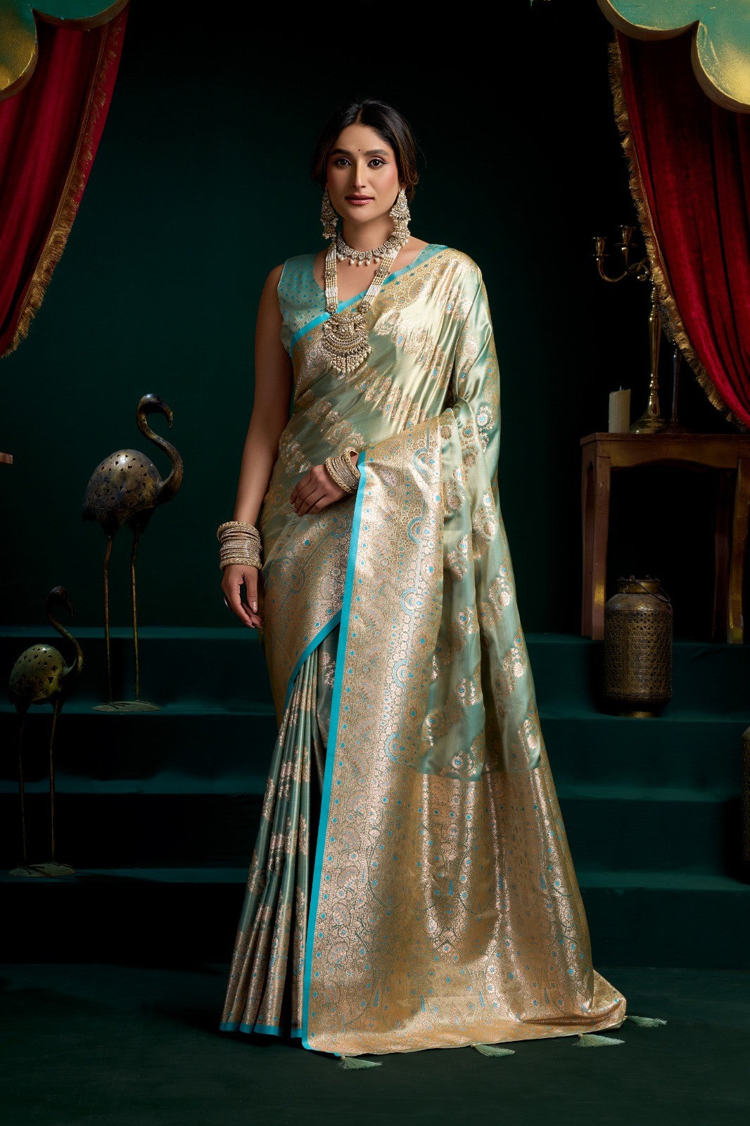 AMAB olive green silk blend saree with intricate zari weaving and contrasting blue border. Traditional motifs.