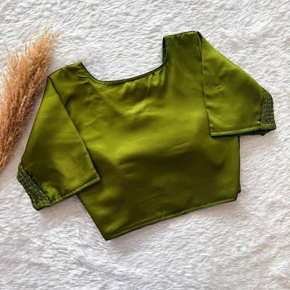 AMAB olive green pure silk blouse with elastic fit and padded comfort. Features a square neckline and smocked cuffs.