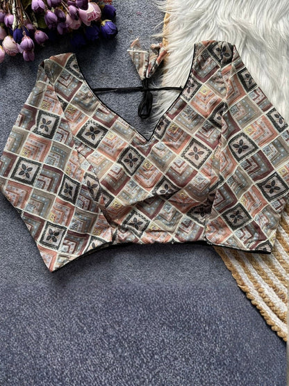 AMAB designer printed blouse with a V-neck and tie-back closure. Features a geometric pattern in brown, beige, and grey.