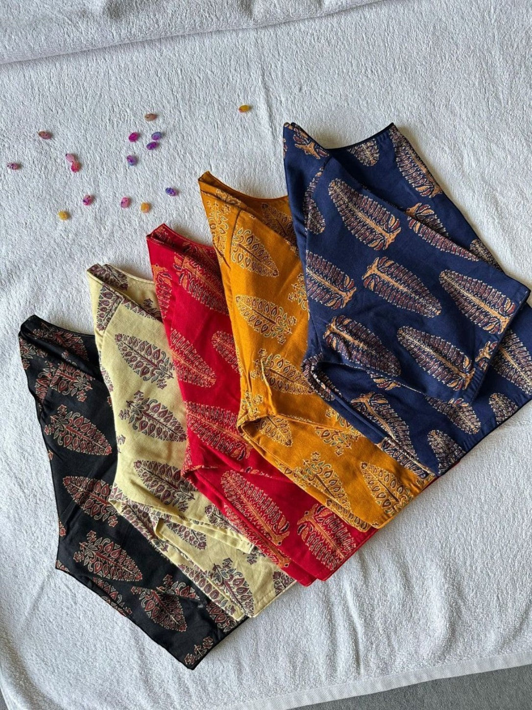 AMAB Pure Ajrakh handblock cotton blouses in black, cream, red, yellow, and navy blue with feather print. Princess cut, boat neck.
