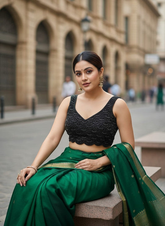 AMAM Pure Silk Blouse with black bead and crystal handwork, V-neck, sleeveless, paired with a green silk saree.