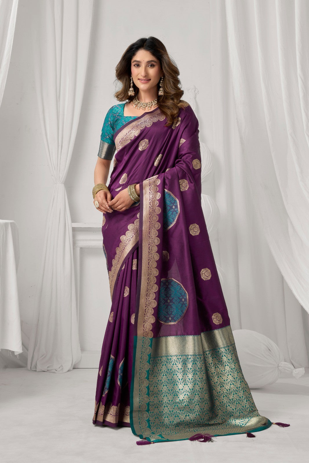 AMAB purple Kanjeevaram silk saree with gold and teal intricate border and circular motifs. Model wears teal blouse.
