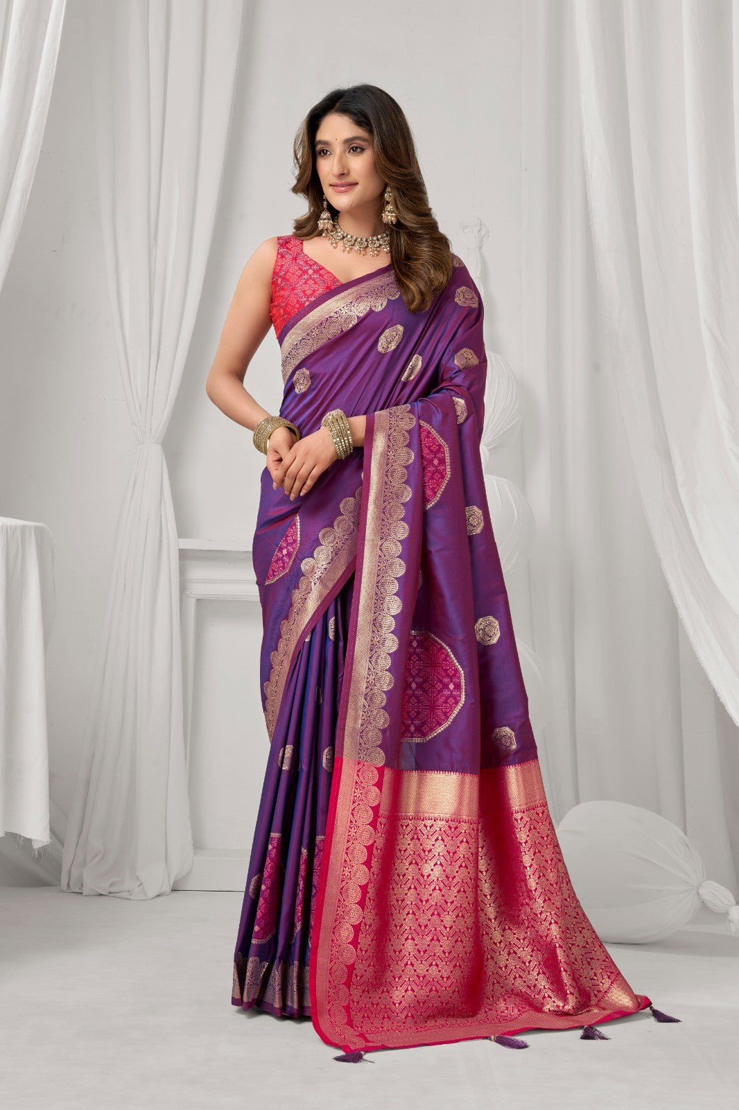 AMAB purple Kanjeevaram silk saree with gold zari border and circular motifs. Features a pink blouse and ornate pallu.