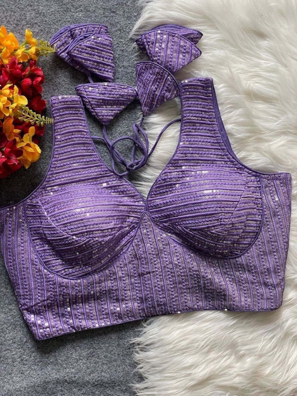 AMAB purple heavy georgette partywear blouse with intricate embroidery and sequence work, deep neck, padded cups, and back tie closure.