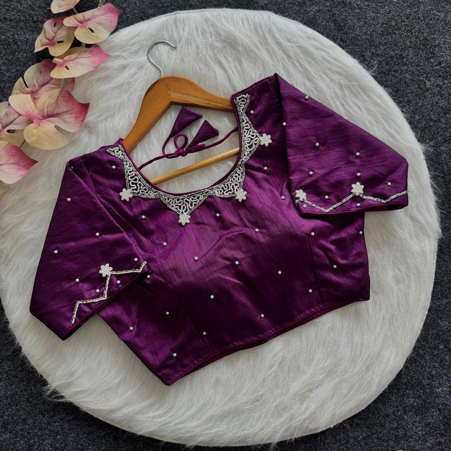 AMAB purple silk blouse with all-over handwork, pearl embellishments, and padded design. Features intricate neckline and sleeve detailing.