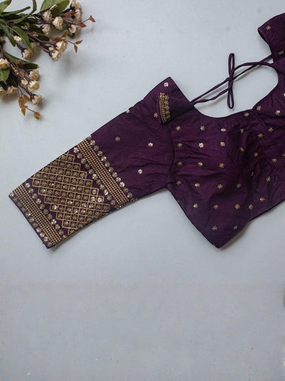 AMAB purple Vichitra silk blouse with gold zari and sequence embroidery, V-neck, and tie closure.