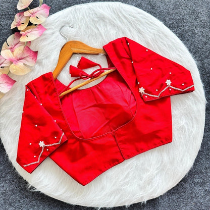 AMAB red silk blouse with all-over handwork, padded, and tie-up back. Festive ethnic wear.