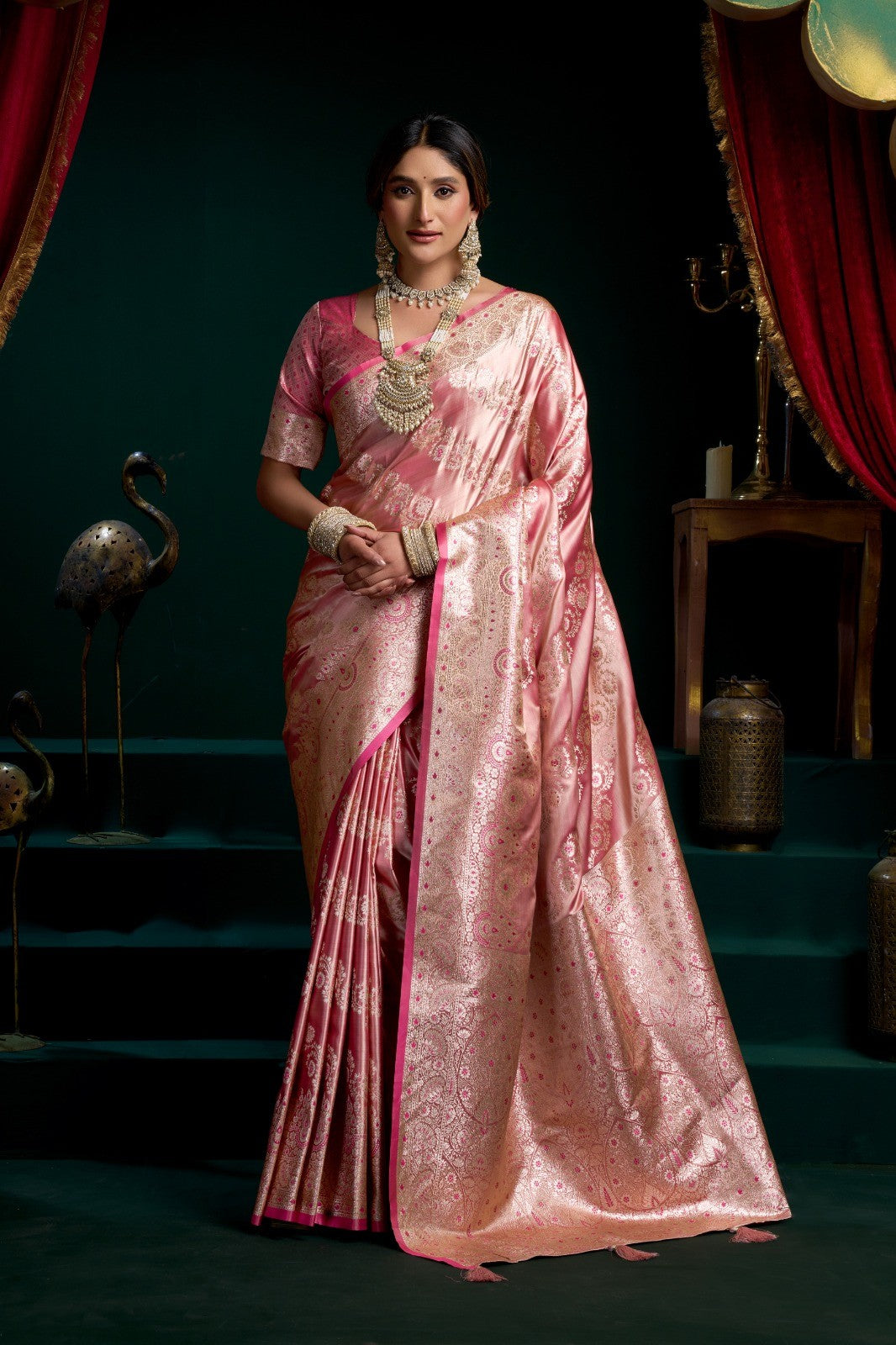 AMAB rose pink silk blend saree with intricate zari weaving and a contrasting pink border. Features traditional motifs and a rich pallu.
