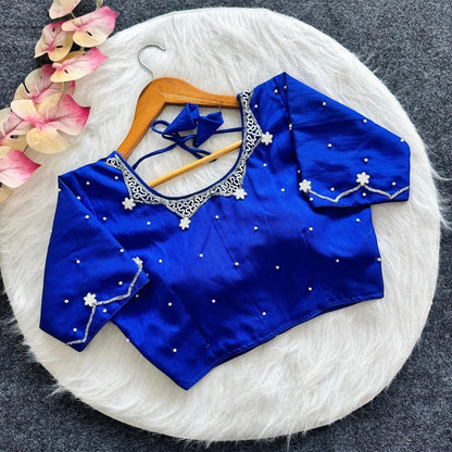AMAB royal blue silk blouse with all-over handwork, padded, and tie-back closure. Features intricate silver embroidery and pearl embellishments.