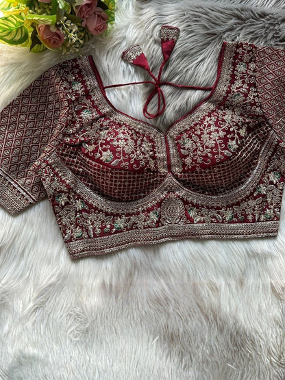AMAB Sabyasachi-inspired maroon Roman silk bridal blouse with heavy gold zari and sequence embroidery. Back open design with latkans.