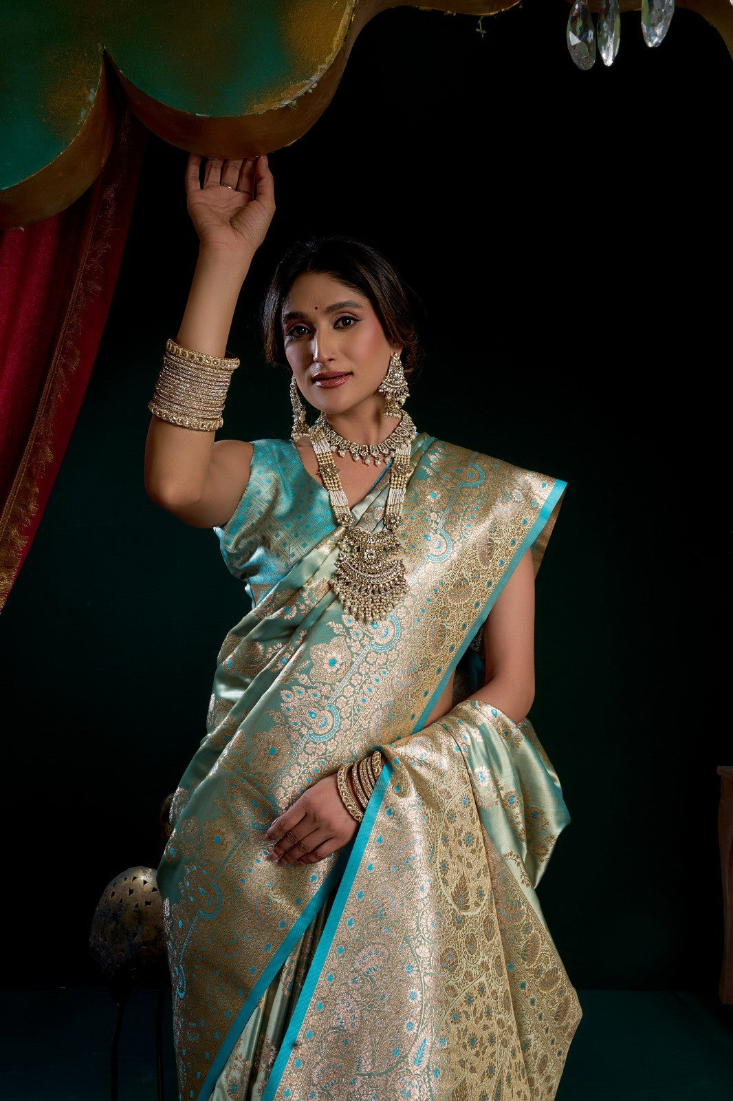 AMAB traditional silk blend saree in seafoam green with gold zari weaving and blue border. Model wears matching jewelry.