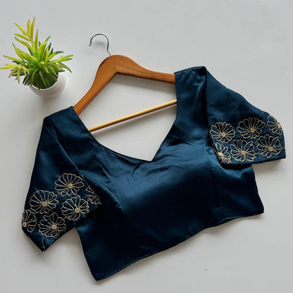 AMAB designer blouse in teal Dilruba silk with golden handwork floral embroidery on sleeves and V-neck.