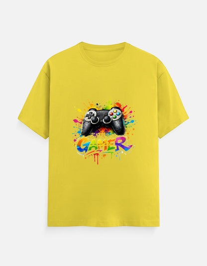 AMAB yellow cotton t-shirt with a black video game controller graphic and colorful paint splatters, text reads GAMER.