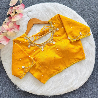 AMAB yellow silk blouse with all-over handwork, pearl embellishments, and floral embroidery on sleeves and neckline.