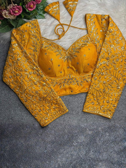 AMAB yellow heavy Vichitra silk blouse with long sleeves, jari and sequence embroidery, and back open design.